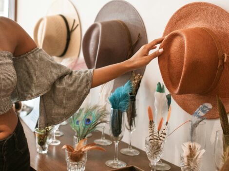 kobieta sięgająca po kapelusz